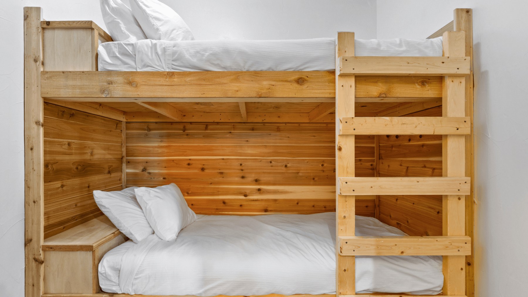 a wooden bed sitting in a room